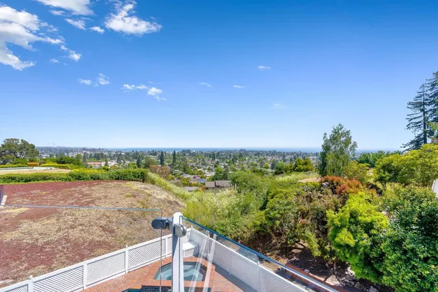 a view of balcony with a large window and wooden floor