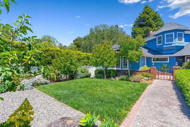 a front view of a house with a garden