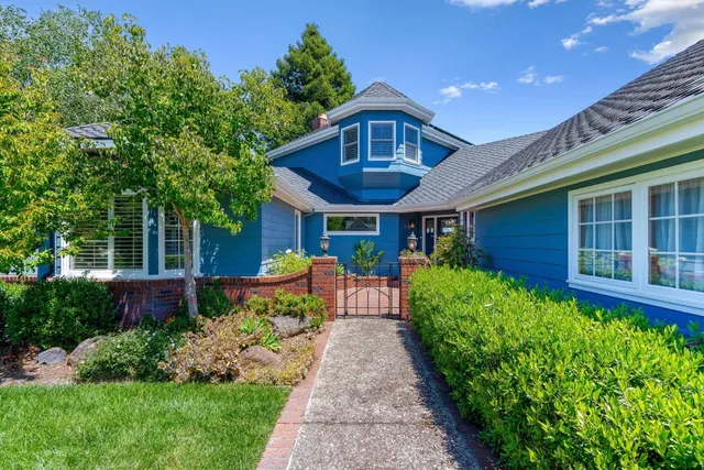 a living room with furniture wooden floor and a large window