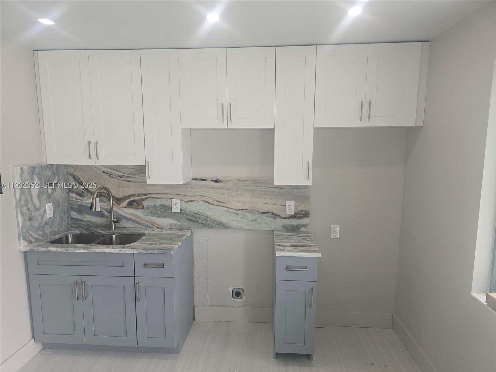 3300 Southeast 6th Street, Unit 6 Pompano Beach, FL 33062 - Photo 1 of 7 a kitchen with white cabinets and sink