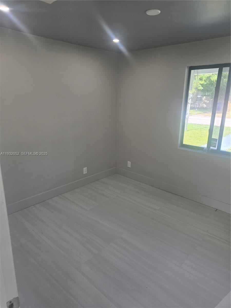 3300 Southeast 6th Street, Unit 6 Pompano Beach, FL 33062 - Photo 2 of 7 an empty room with windows