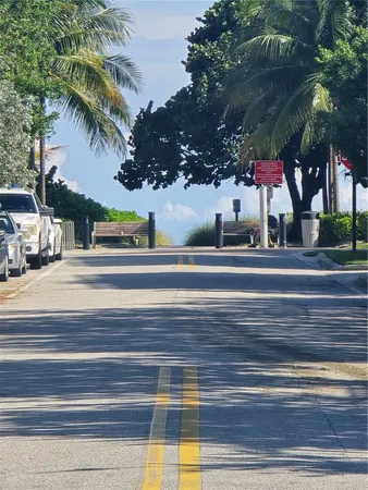 a view of street along with house and trees