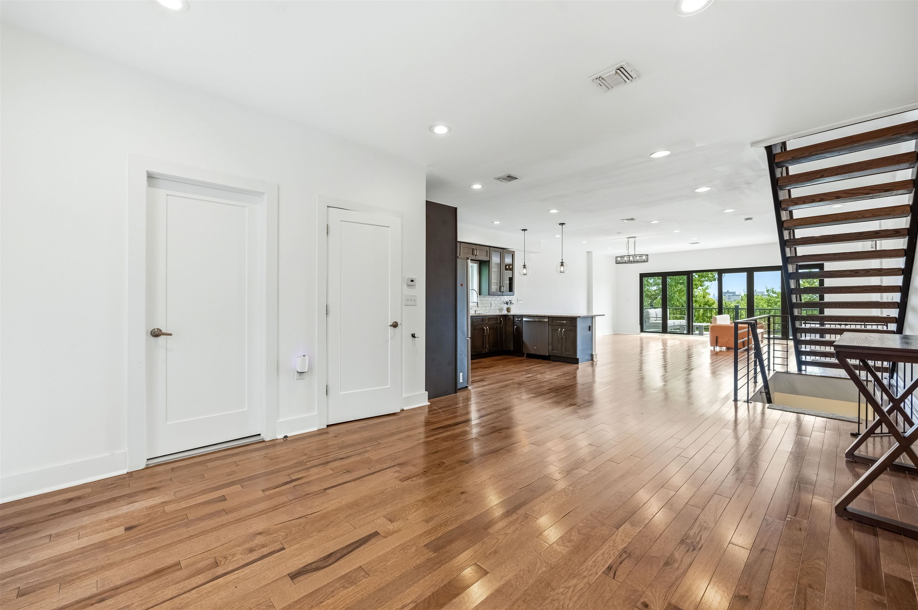 107 Mountain Road Jersey City, NJ 07307 - Photo 4 of 41 a view of empty room with wooden floor and windows