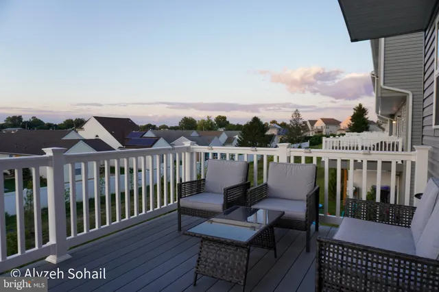 a view of a balcony with wooden benches