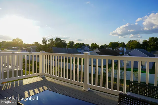 a view of a balcony with wooden floor and fence