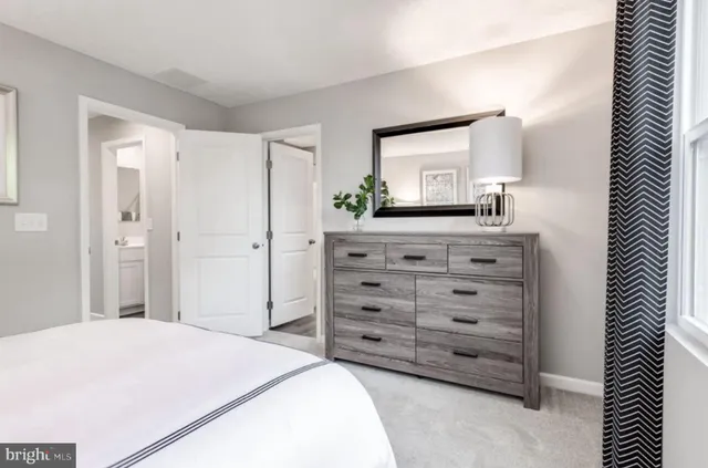 a bedroom with a bed and a dresser