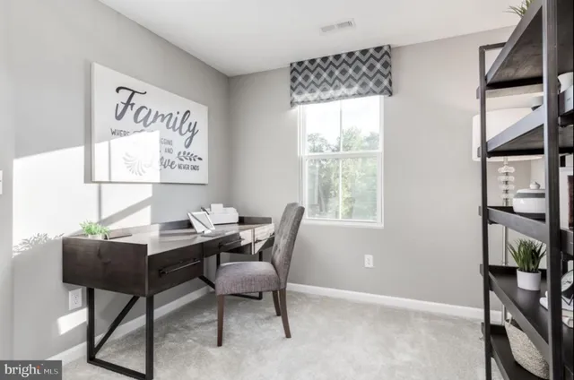 a work room with furniture and a window