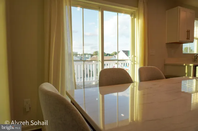 a balcony with furniture and a potted plant
