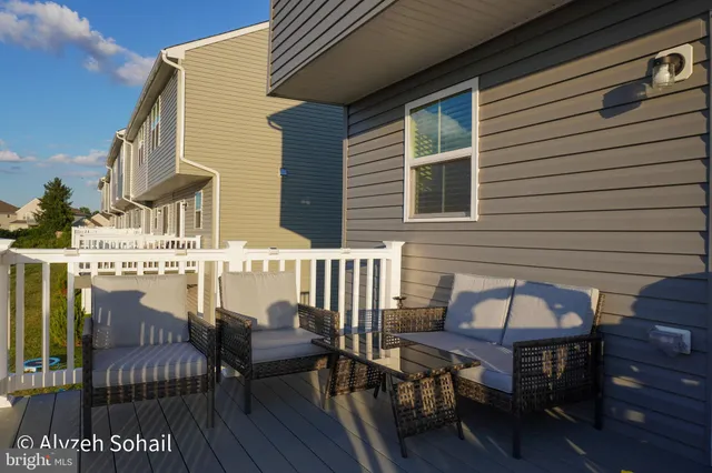 a view of a chairs and table in the balcony