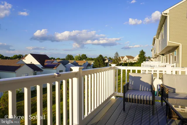 a view of a balcony with wooden chairs