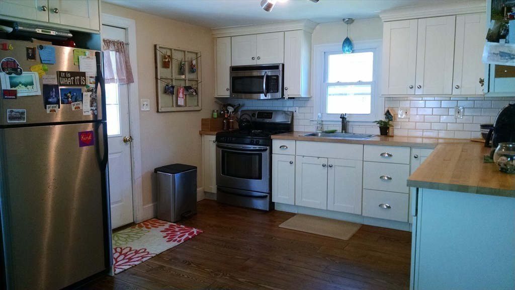 57 Sturbridge Road Holland, MA 01521 - Photo 3 of 18 a kitchen with stainless steel appliances granite countertop a refrigerator stove top oven and sink