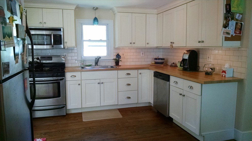 57 Sturbridge Road Holland, MA 01521 - Photo 5 of 18 a kitchen with white cabinets stainless steel appliances and a sink