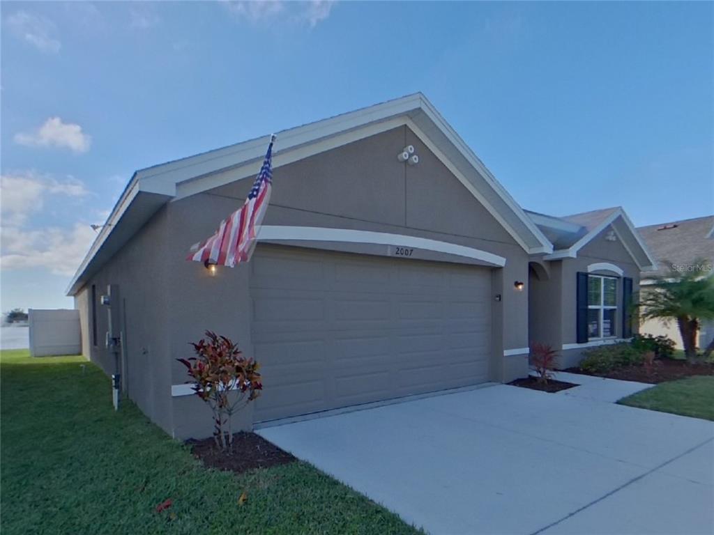 Undisclosed Address Ruskin, FL 33570 - Photo 1 of 18 a front view of a house with a yard