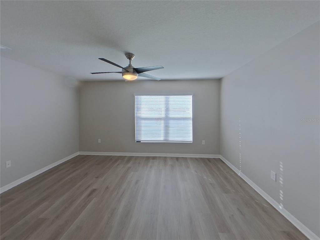 Undisclosed Address Ruskin, FL 33570 - Photo 2 of 18 wooden floor in an empty room with a window