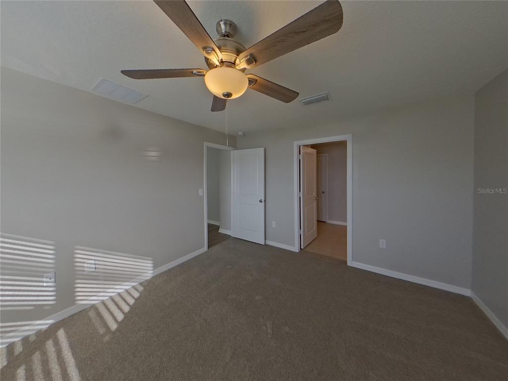 Undisclosed Address Ruskin, FL 33570 - Photo 8 of 18 en empty room with windows and fan