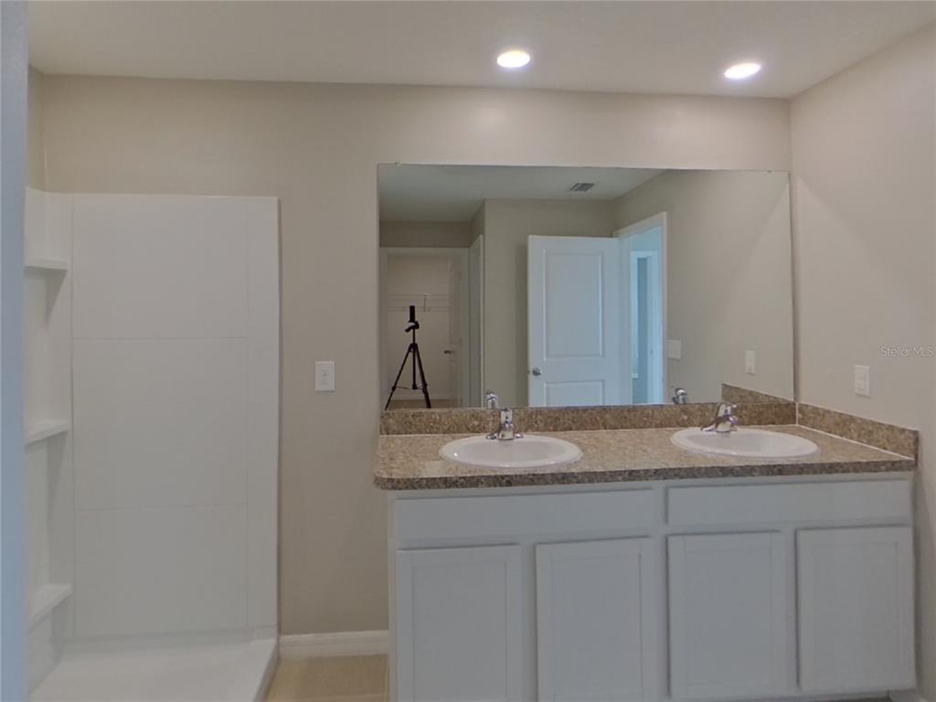 Undisclosed Address Ruskin, FL 33570 - Photo 9 of 18 a bathroom with a granite countertop sink and a mirror