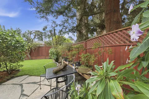 a backyard of a house with table and chairs