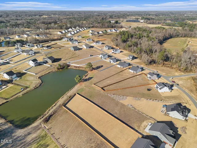an aerial view of a house with a lake view