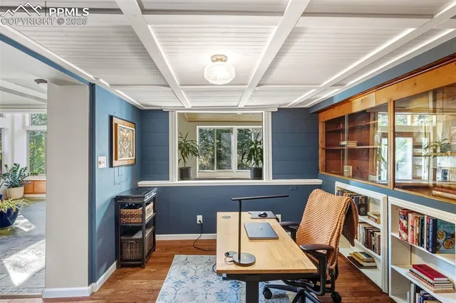 a living room with furniture a flat screen tv and a large window