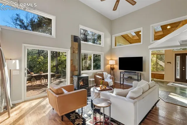a living room with furniture and a floor to ceiling window