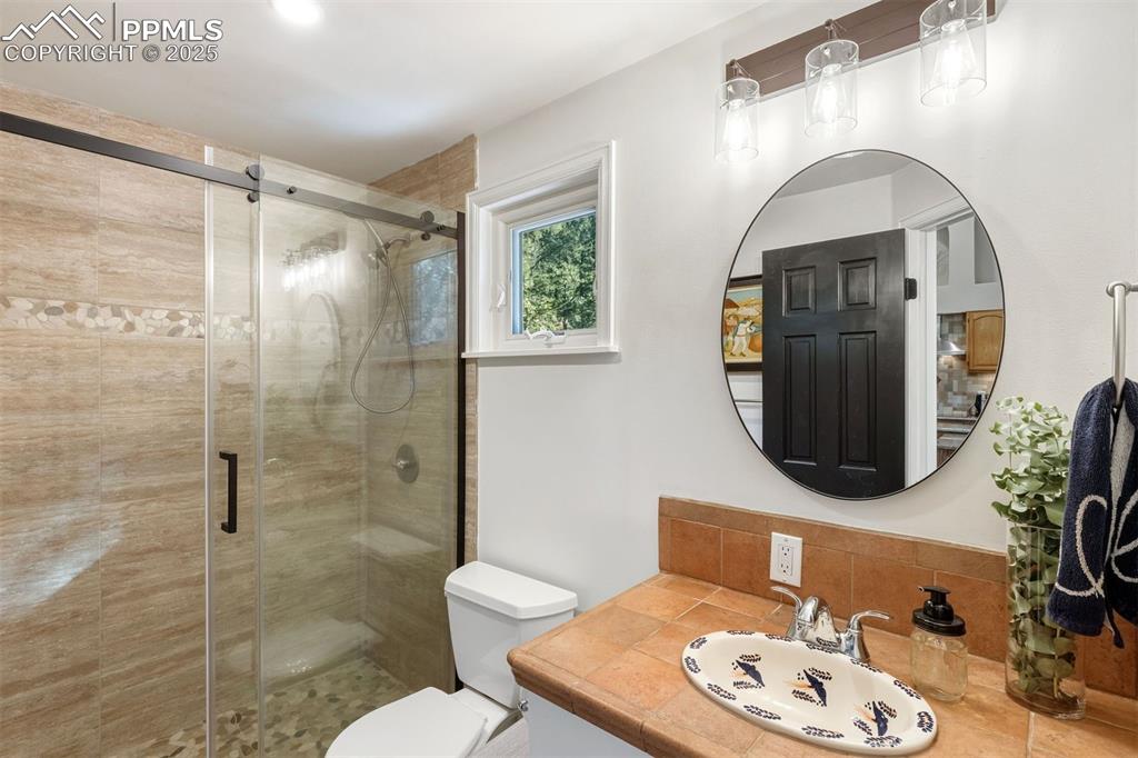 1144 Rock Creek Canyon Road, Unit A Colorado Springs, CO 80926 - Photo 19 of 50 a bathroom with a sink toilet and shower