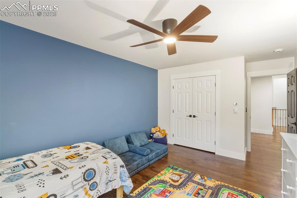 1144 Rock Creek Canyon Road, Unit A Colorado Springs, CO 80926 - Photo 23 of 50 a bedroom with a bed and a chandelier