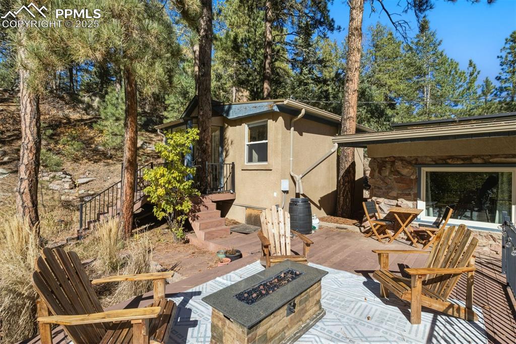 1144 Rock Creek Canyon Road, Unit A Colorado Springs, CO 80926 - Photo 33 of 50 a view of a patio with table and chairs and potted plants