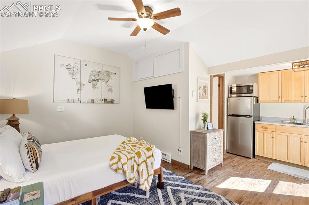 1144 Rock Creek Canyon Road, Unit A Colorado Springs, CO 80926 - Photo 37 of 50 a living room with kitchen island furniture and a flat screen tv