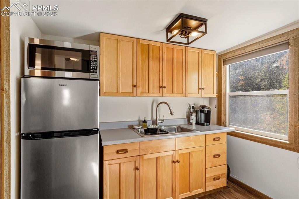 1144 Rock Creek Canyon Road, Unit A Colorado Springs, CO 80926 - Photo 38 of 50 a kitchen with a refrigerator and a sink