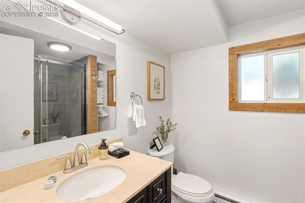 1144 Rock Creek Canyon Road, Unit A Colorado Springs, CO 80926 - Photo 39 of 50 a bathroom with a sink vanity mirror and toilet
