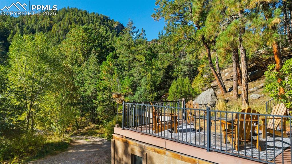 1144 Rock Creek Canyon Road, Unit A Colorado Springs, CO 80926 - Photo 41 of 50 a view of balcony with wooden floor and fence