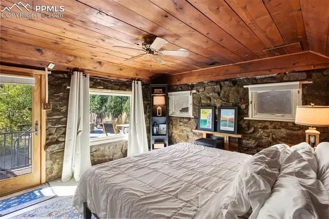 a bed room with a bed and a large window