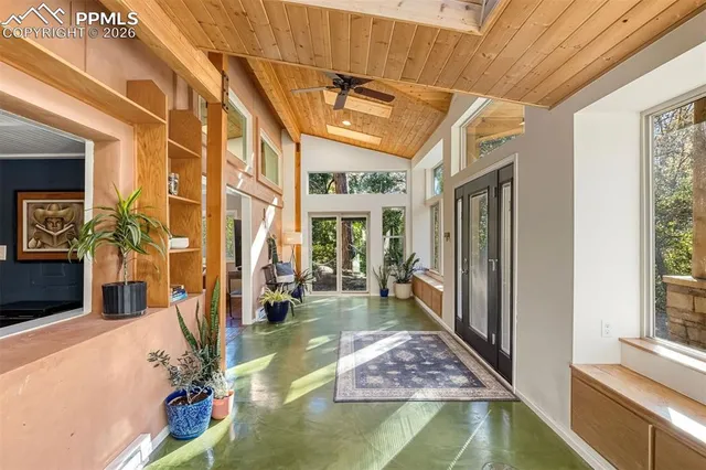 a living room with furniture and a floor to ceiling window