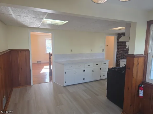 a view of wooden floor and windows in a room