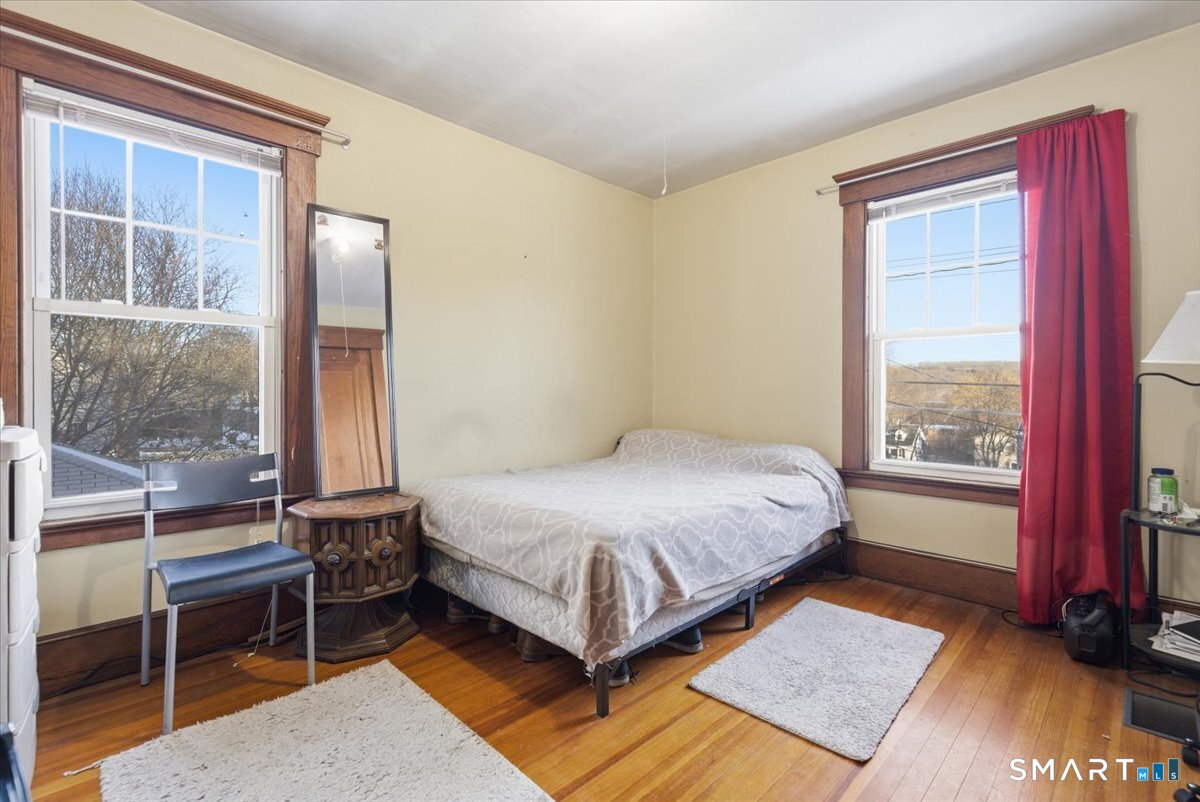 93 Cannon Street Hamden, CT 06518 - Photo 15 of 38 a bedroom with a bed lamp and a large window