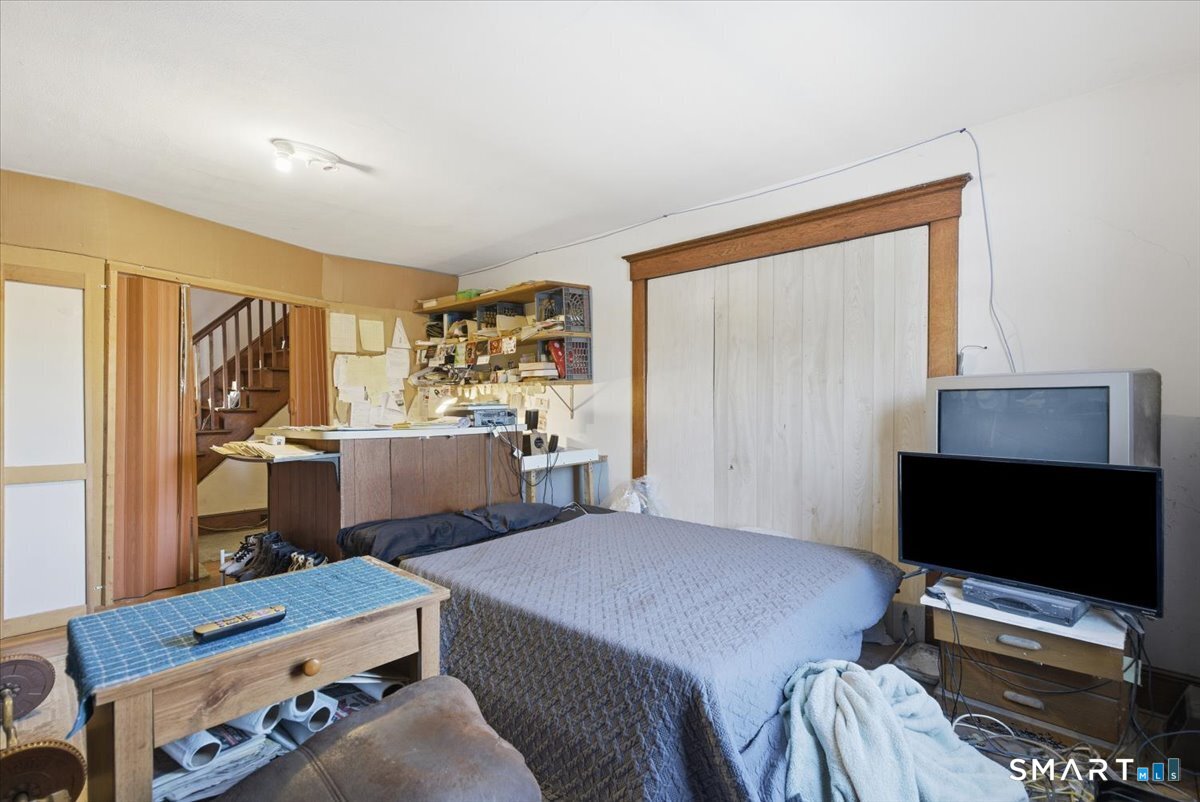 93 Cannon Street Hamden, CT 06518 - Photo 6 of 38 a bedroom with a bed and a flat screen tv