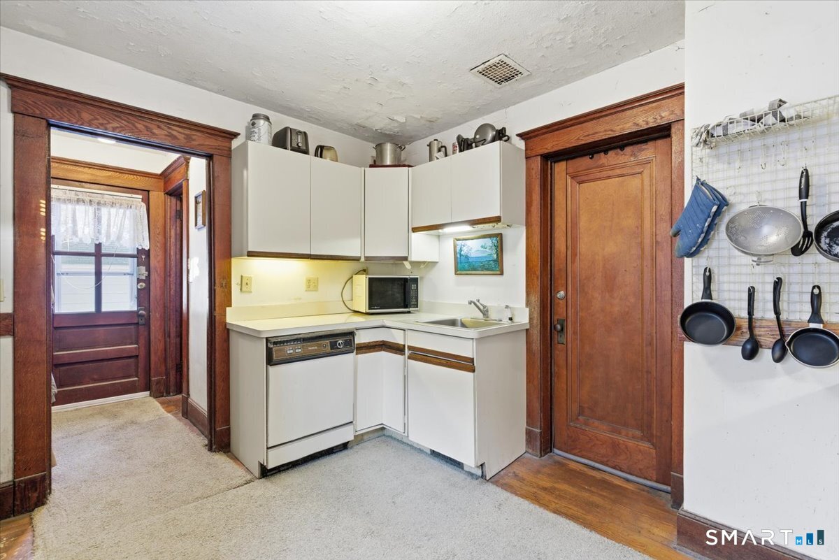 93 Cannon Street Hamden, CT 06518 - Photo 7 of 38 a kitchen with stainless steel appliances a stove and a refrigerator