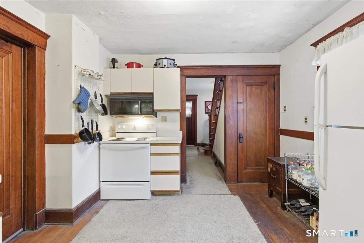 93 Cannon Street Hamden, CT 06518 - Photo 9 of 38 a kitchen with a refrigerator and a stove