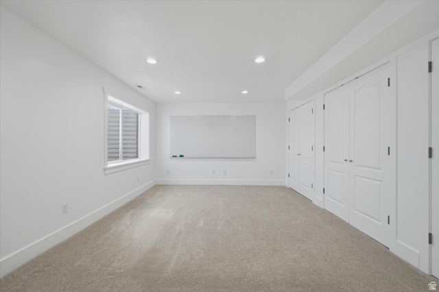 791 East Saddle Road Grantsville, UT 84029 - Photo 29 of 46 Carpeted room featuring a single window, recessed lighting, white walls, and a row of white bi-fold closet doors