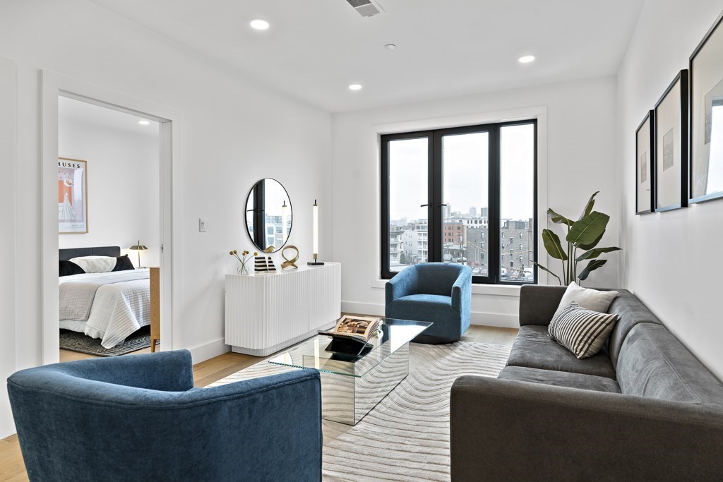 a living room with furniture and a large window