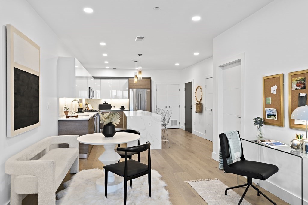 30 Penniman Road, Unit 408 Boston, MA 02134 - Photo 3 of 5 a living room with furniture and a flat screen tv
