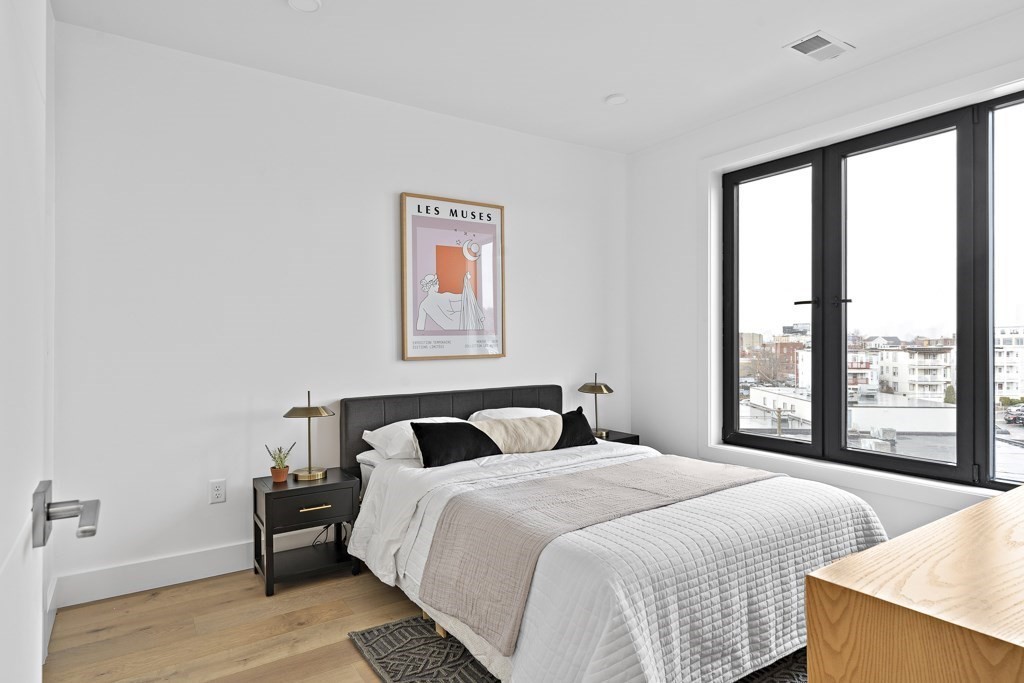 30 Penniman Road, Unit 408 Boston, MA 02134 - Photo 4 of 5 a bedroom with a large bed and a large window