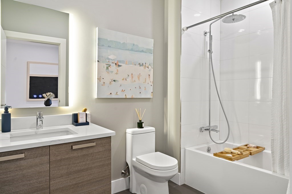 30 Penniman Road, Unit 408 Boston, MA 02134 - Photo 5 of 5 a bathroom with a granite countertop sink a toilet and a mirror