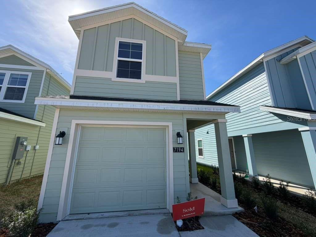 a front view of a house with parking space