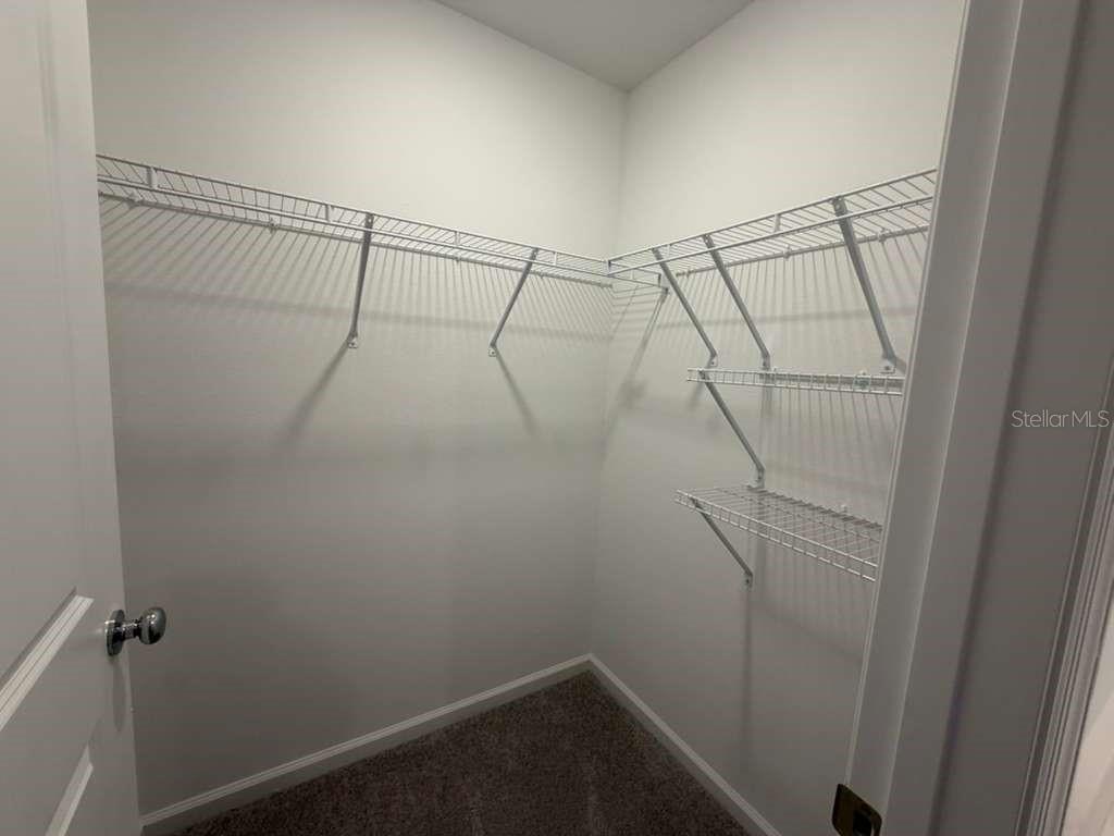 7194 Southwest 91st Lane Ocala, FL 34476 - Photo 9 of 20 a view of a room with racks on the wall