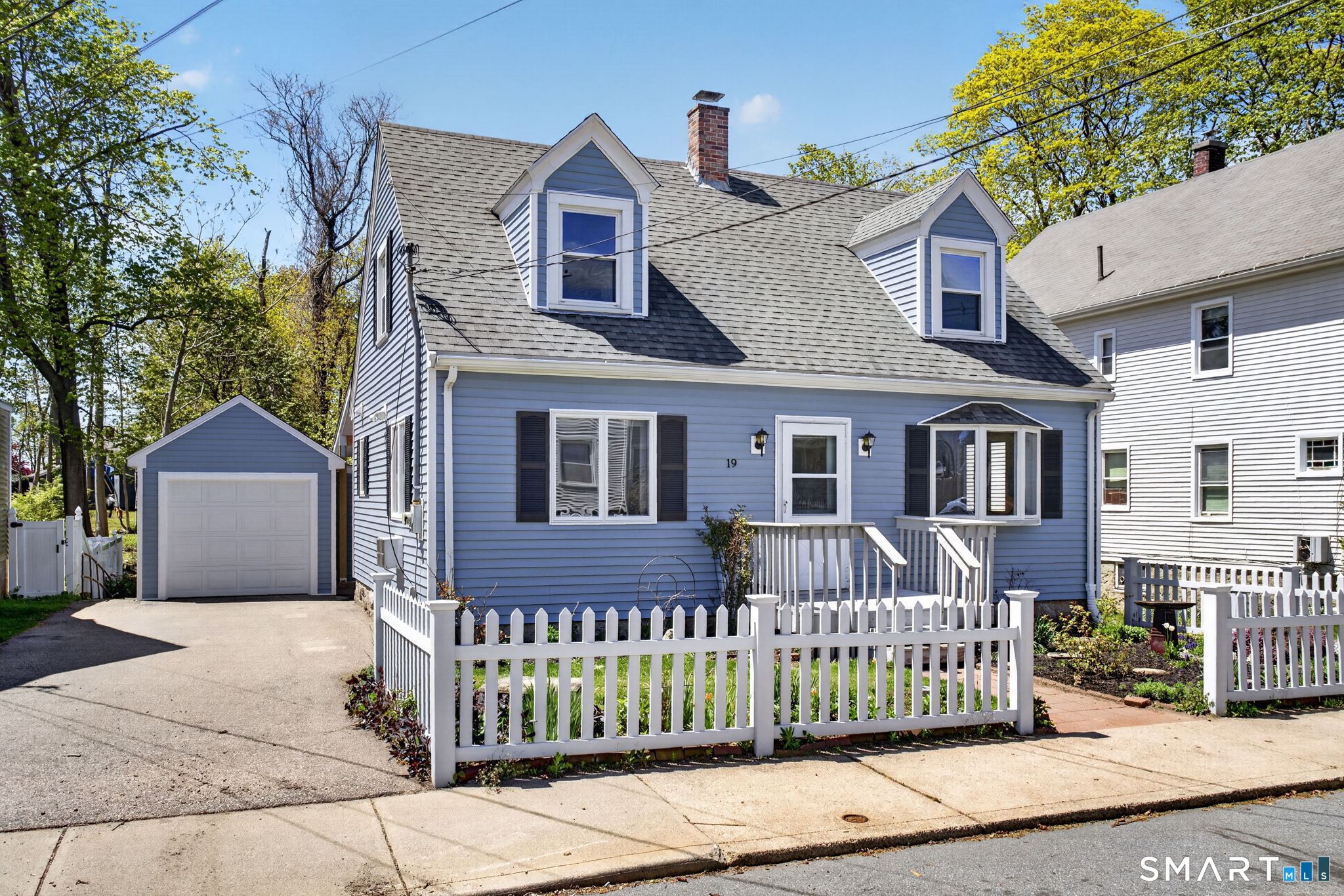 19 High Street Groton, CT 06340 - Photo 1 of 38 a front view of a house with a garden