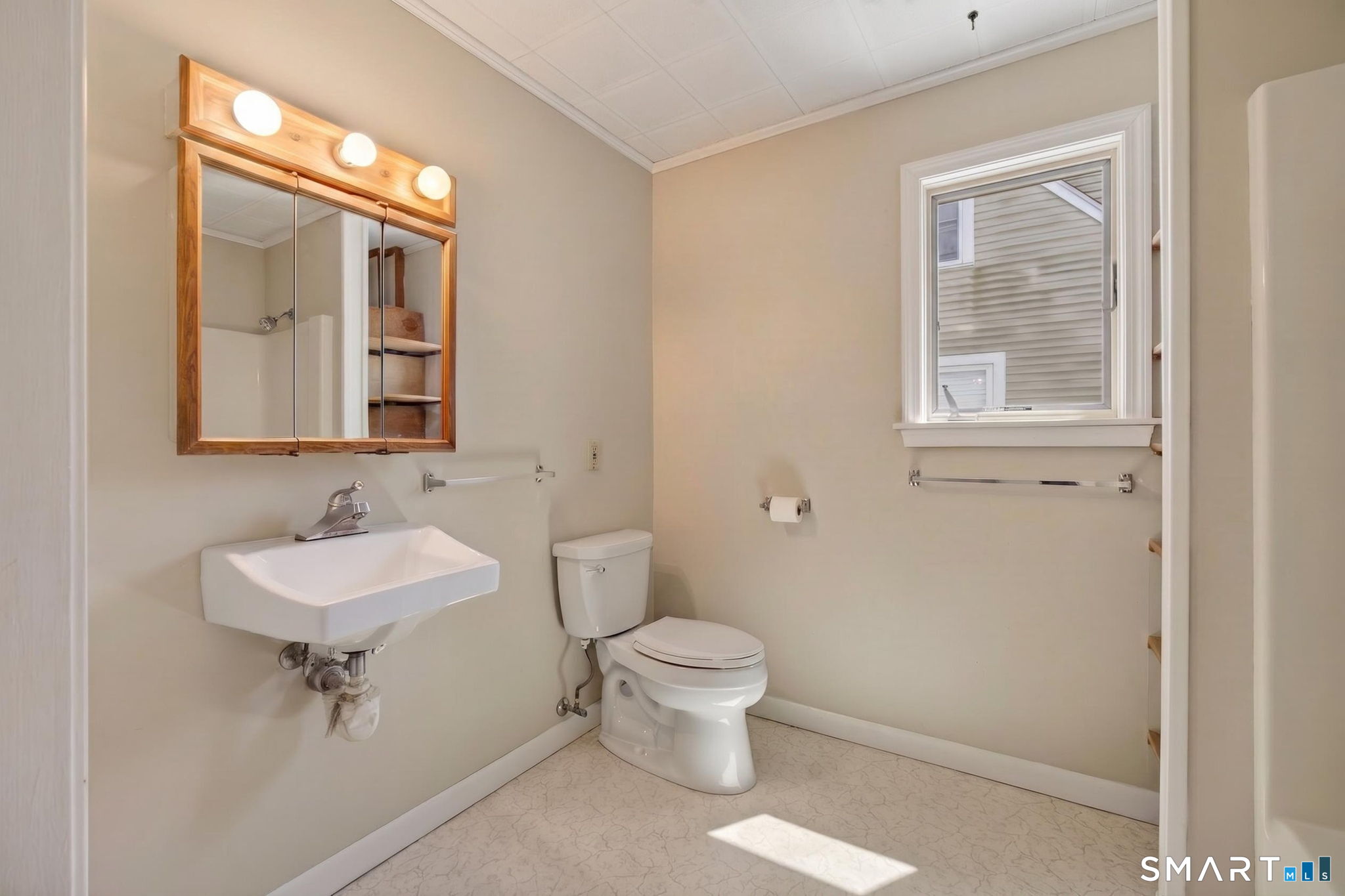 19 High Street Groton, CT 06340 - Photo 19 of 38 a bathroom with a toilet a sink and mirror