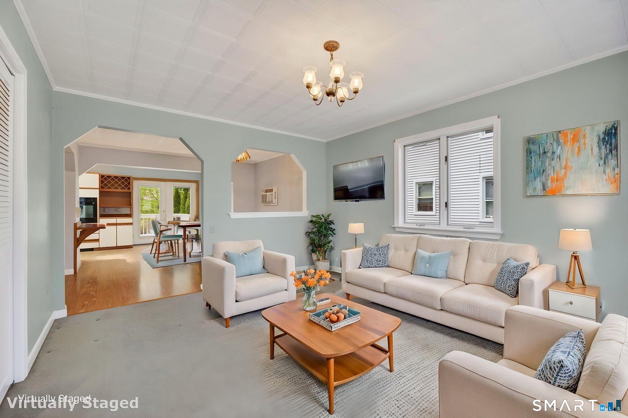 19 High Street Groton, CT 06340 - Photo 3 of 38 a living room with furniture and a chandelier