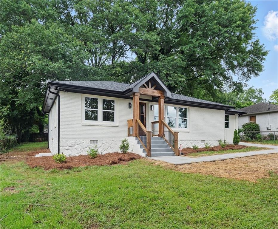 a view of a house with yard and a garden