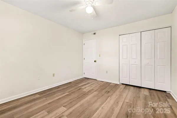 a view of a room with wooden floor
